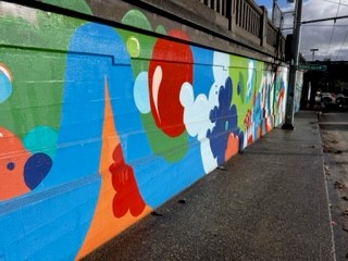 Image of the mural on 46th St Seattle after pressure washing has been finished showing a different section