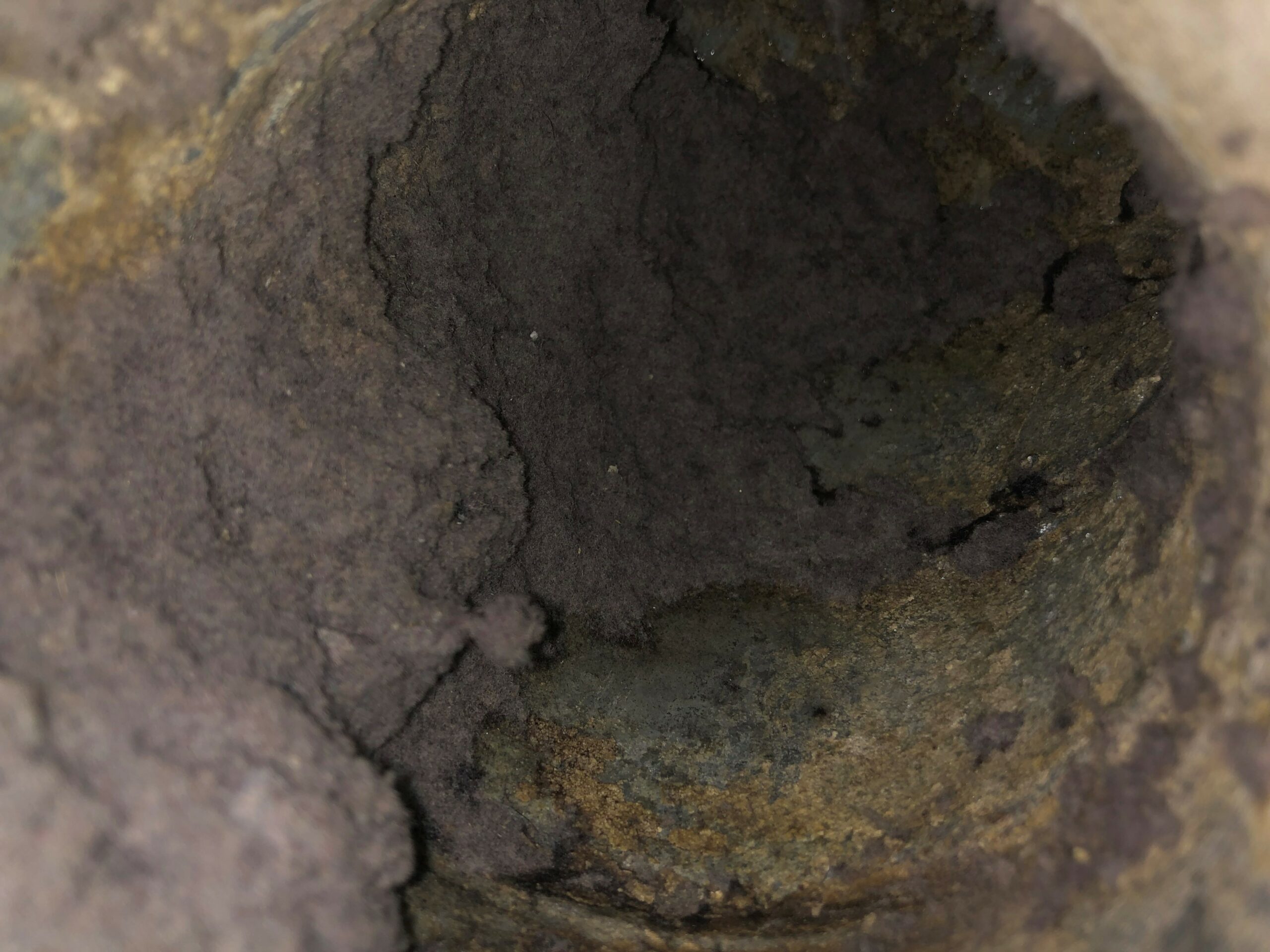 A dryer duct full of lint and debris, possibly also containing mold. 