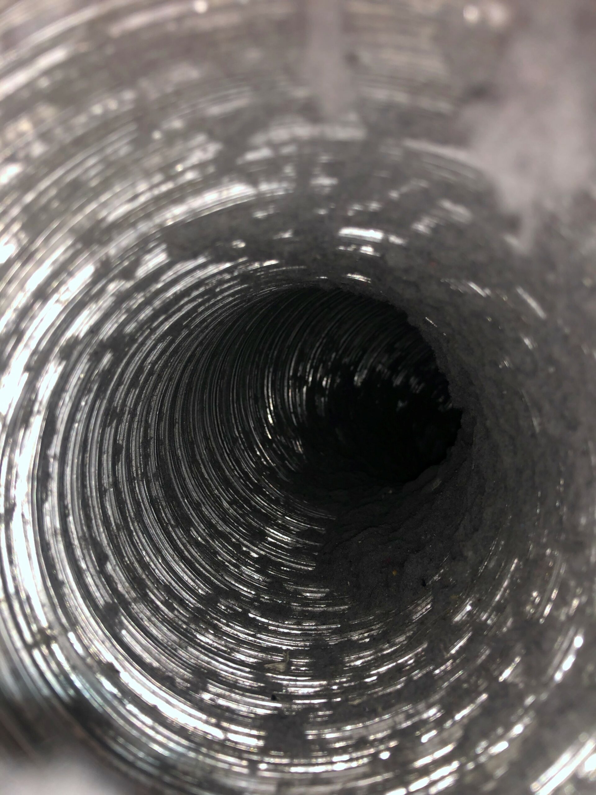 A metal dryer duct tube that has been cleaned to remove lint and debris